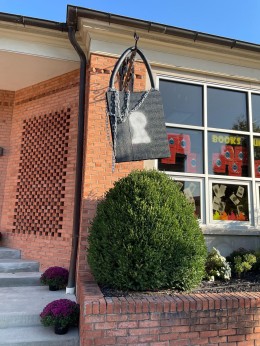 images showing a giant padlock hanging from the library sign and a banned books week window display with the phrase “books unite us censorship divides us.”